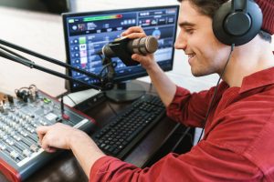image-of-young-happy-dj-man-wearing-headphones-working-at-radio-station.jpg