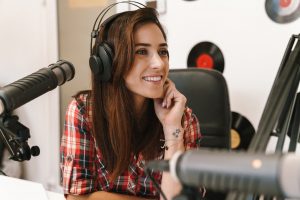 image-of-young-happy-dj-woman-wearing-headphones-working-at-radio-station.jpg