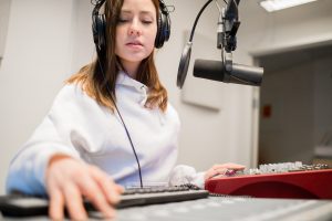 radio-jockey-wearing-headphones-in-studio.jpg
